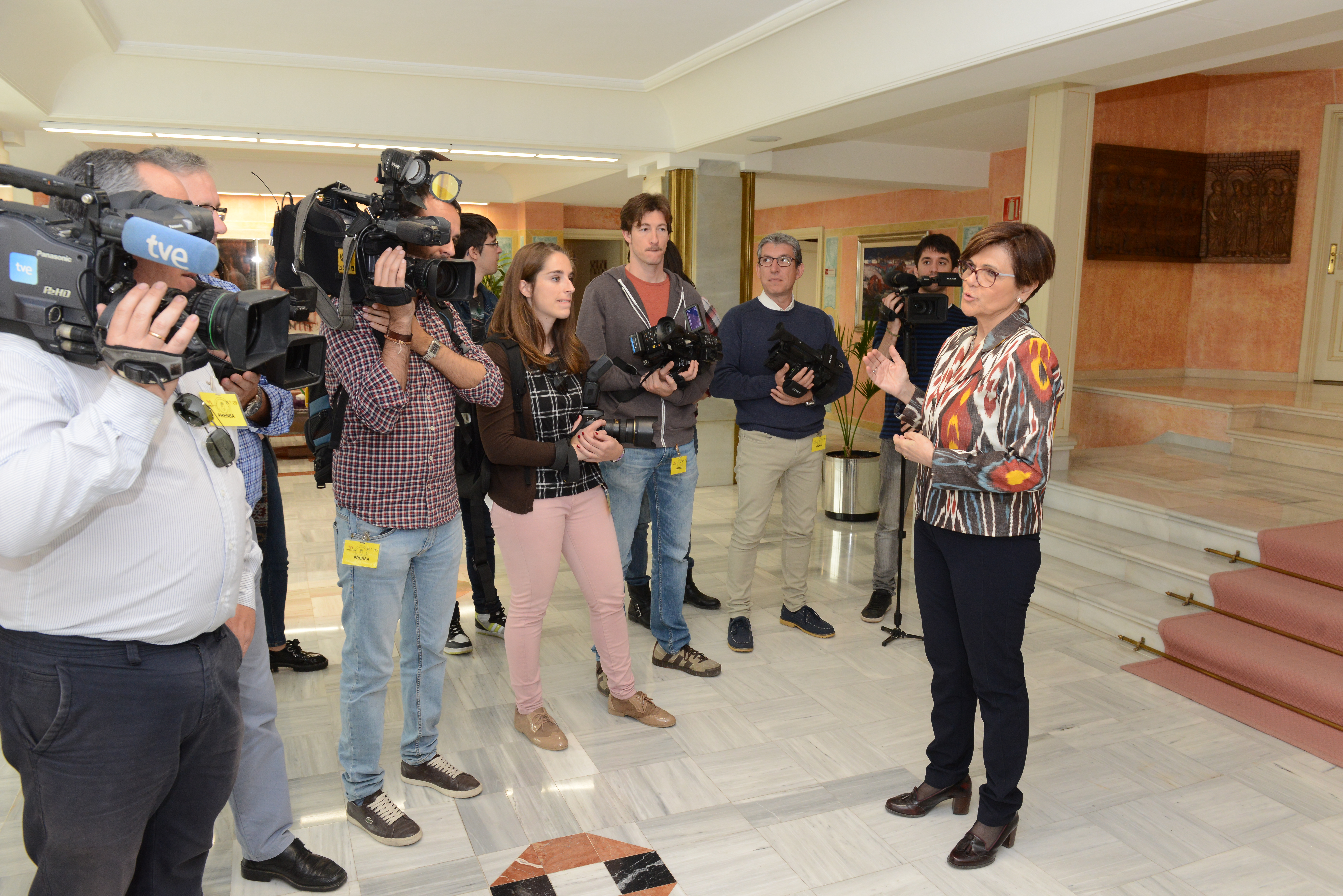 La presidenta de la Asamblea conversa con los medios a la entrada del Salón del Príncipe, mientras espera a un portavoz