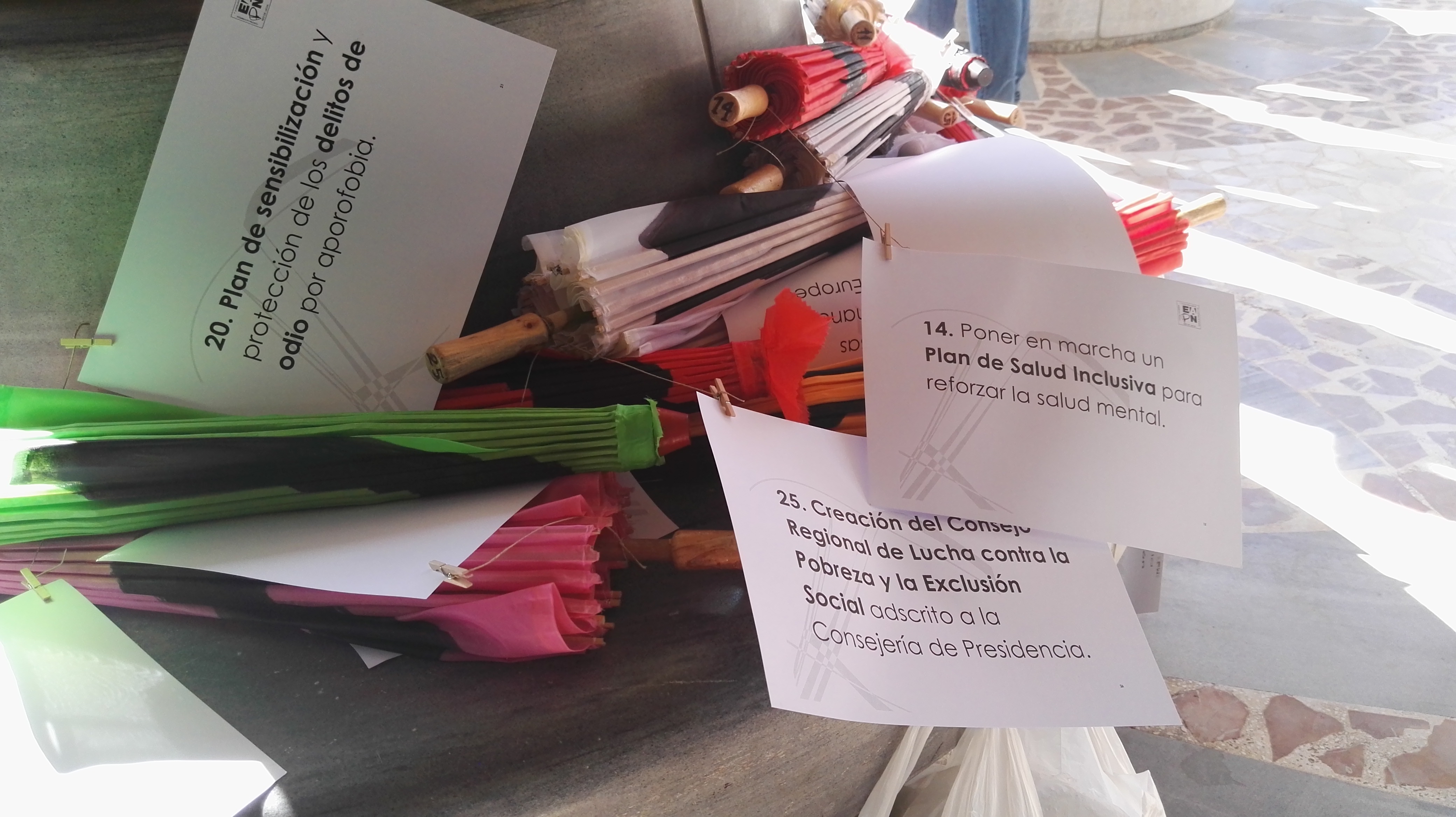 Paraguas con textos reivindicativos, para pedir la firma de un II Pacto contra la Pobreza y la Exclusión Social